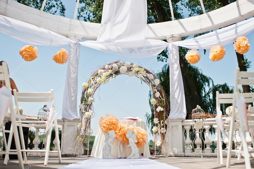 wedding arch with chairs and many flowers and decor
