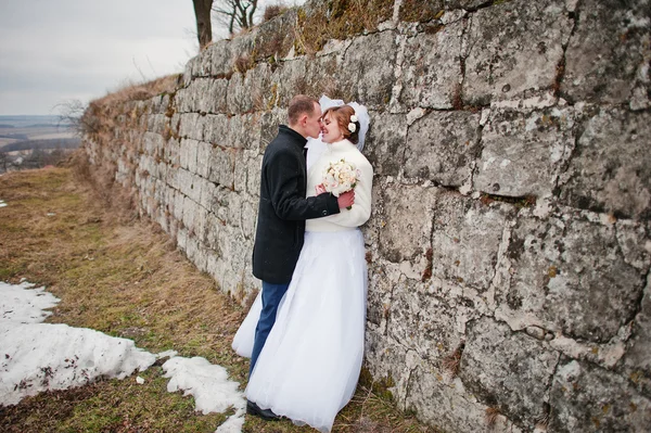 Fiatal esküvői pár téli háttér stone landskape és wa — Stock Fotó