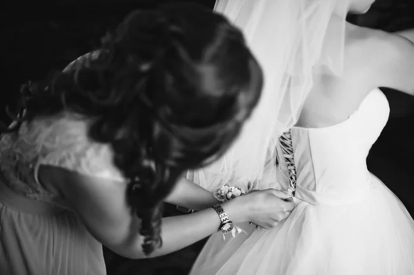 Dama de honor atando vestido de novia — Foto de Stock