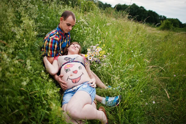 Happy young couple expecting baby, pregnant woman with painted b — Stock Photo, Image