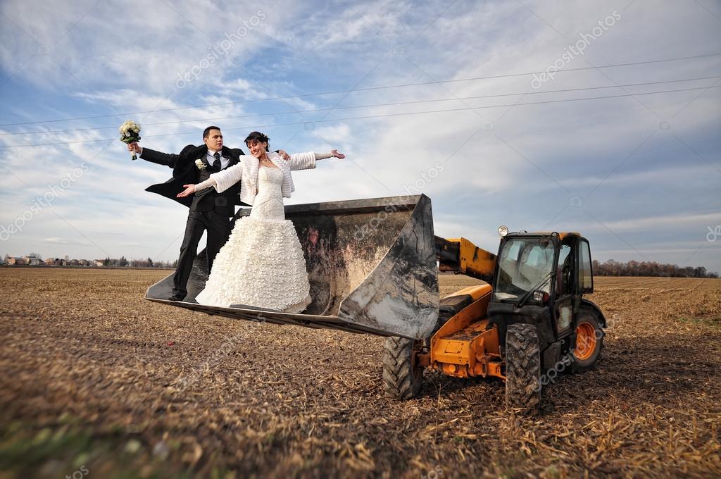 Happy and funny wedding couple in a scoop tractor Stock Photo by ©ASphoto777 92457280 Happy and funny wedding couple in a scoop tractor Stock Photo by ©ASphoto777 92457280