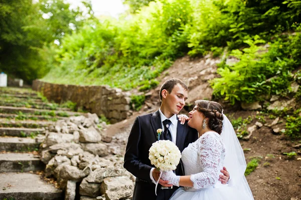 Bruidspaar in liefde in de buurt van stenen trap — Stockfoto