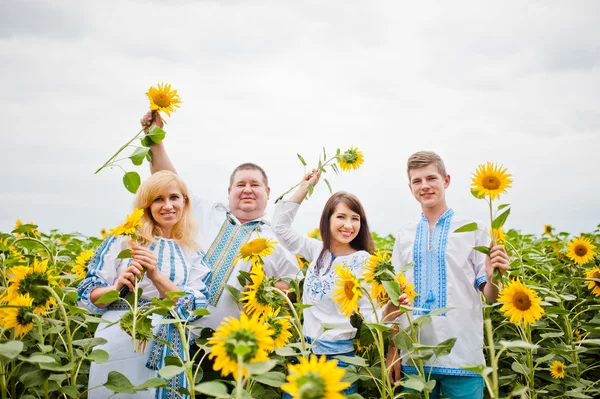 Happy family having fun on sunflowers — Stock Photo, Image