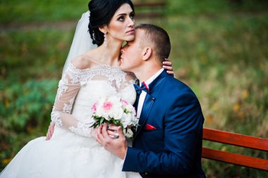 Parkta bankta oturan genç şık Düğün çifti