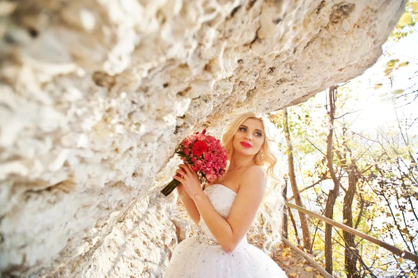 Charming blonde bride  on landscapes of mountains, near cave wit — Stock Photo, Image