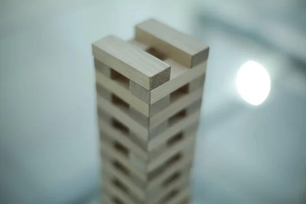 Board game - wooden bars on a glass table in office