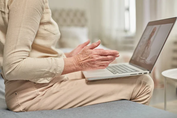 Yaşlı bir kadın, doktoruyla bilgisayarla uzaktan iletişim kuruyor. Teletıp kavramı