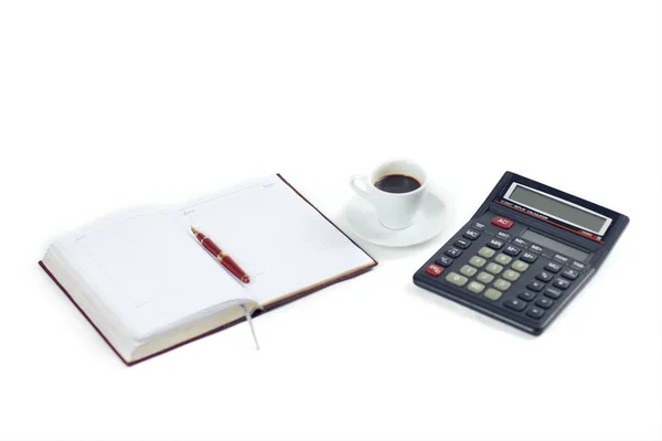 Notepad pen coffee cup black calculator isolated on white background — Zdjęcie stockowe