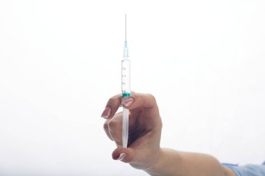 The doctor holds a syringe in his hands. Vaccination concept
