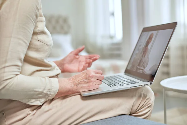Yaşlı bir kadın, doktoruyla bilgisayarla uzaktan iletişim kuruyor. Teletıp kavramı