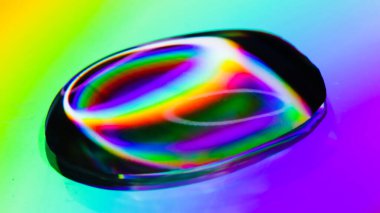 A very colorful and bright drop of water on a CD