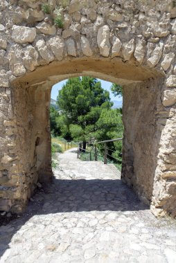 Ortaçağ şatosunun taş duvarından merdivenlere doğru açılan kapı..