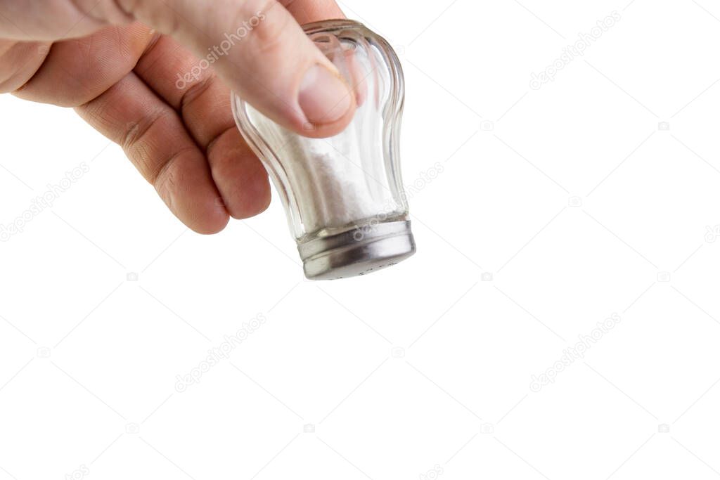 excess salt: saltcellar with the letter S in a man's hand, isolated on white background