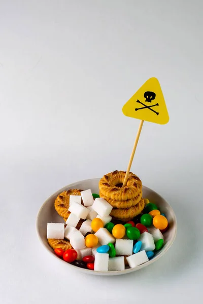 sugar control in diabetes concept: Death sign over a plate with cookies. sweets and sugar