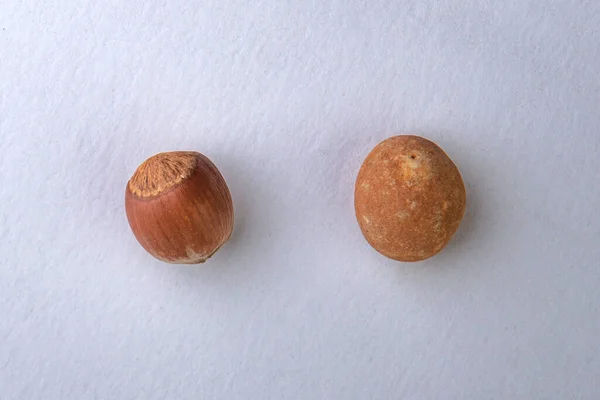 concept: a trap for online shoppers, a nut lies next to a hazelnut-like stone