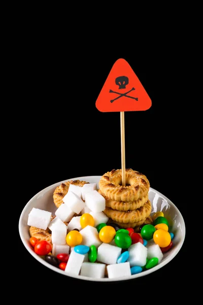 sugar control in diabetes concept: Death sign over a plate with cookies. sweets and sugar