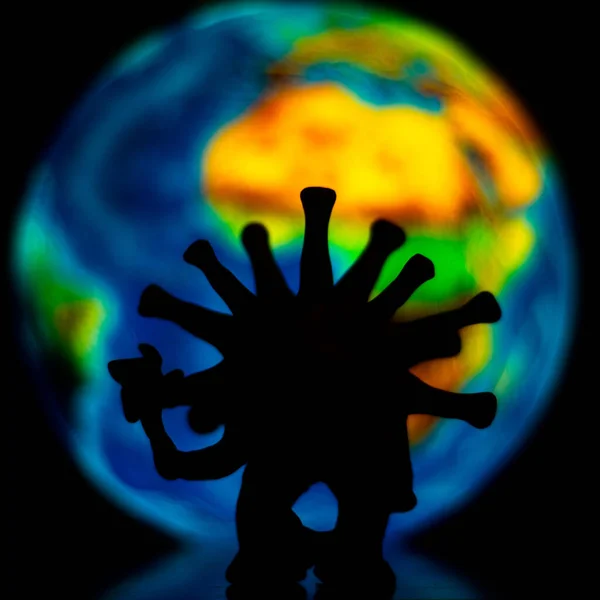 horrible shadow monster virus on a blurred background of planet Earth