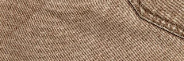 fabric grunge background, real cotton denim, brown, wrinkles, frayed, seam on the canvas, close