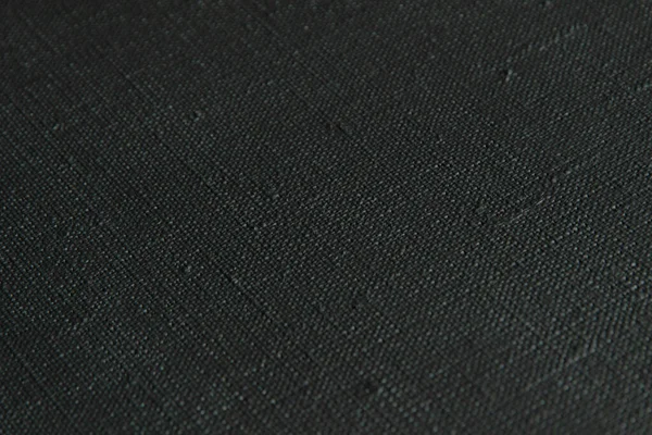 koyu yaratıcı arkaplan: siyah astarlı keten tuval, düzensiz ışıklandırma, ton 