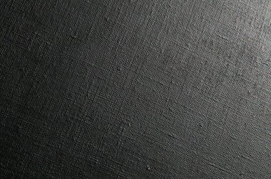 dark creative background: black primed linen canvas, uneven lighting, toning  clipart