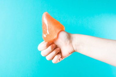 Honey flows down the arm, which shows the thumb up, like, close-up on a blue background