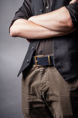 Erkek belinde kül tokası olan siyah deri kemer.