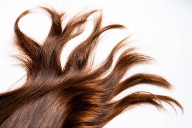 Koyu tahta şekilli saçlar beyaz arka planda yatar.