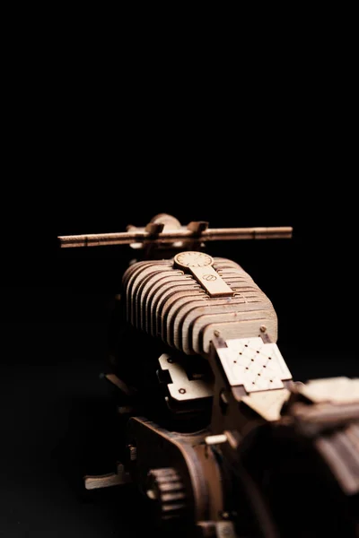 Wooden toy motorcycle on a black background a close up — Stock Photo, Image