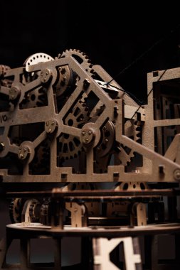 Siyah arka planda, mekanizmanın ahşap dişlileri.