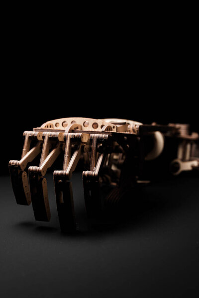 Wooden prosthetic arm on a black background