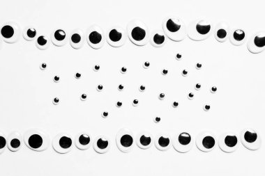 Beyaz arkaplandaki oyuncak gözlerden paralel çizgiler