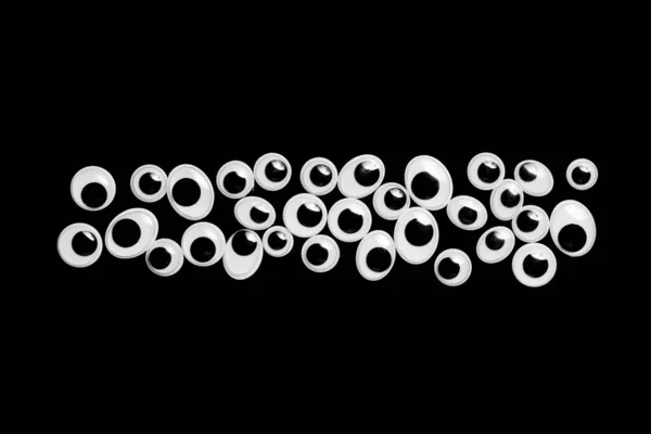 Linie așezată din ochi de jucărie pe fundal negru — Fotografie, imagine de stoc