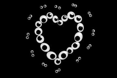 Sülfürik arka planda kalp şeklinde oyuncak gözler.