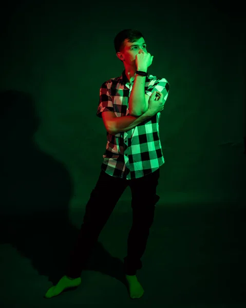 Känslomässig kille i studion med grönt och rött ljus — Stockfoto