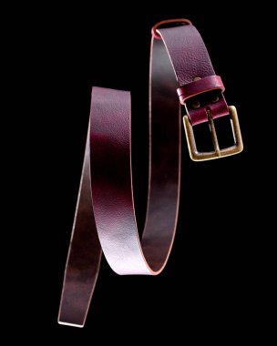 Siyah arka planda bronz tokalı kırmızı deri kemer.