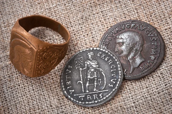 signet ring and two coins of the ancient Roman Empire