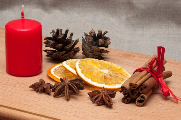 Christmas composition - candle, dried orange, anise, cinnamon. — Stock Photo, Image