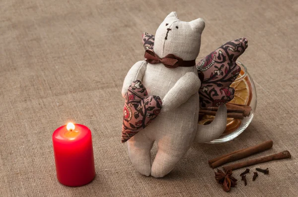 Composition: cat toy, bowl with spices and lit candle — Stock Photo, Image