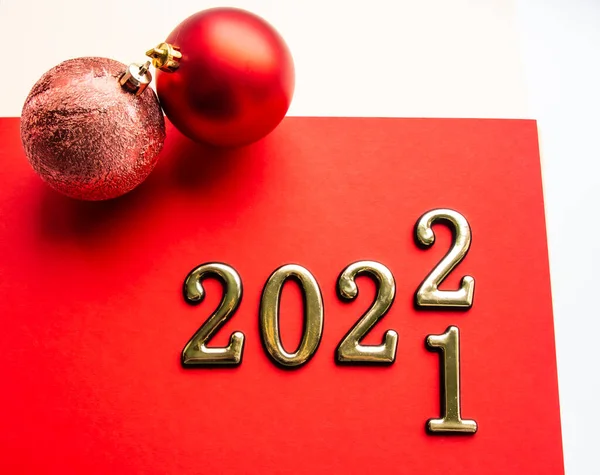 kırmızı noel baloları ve kırmızı zemin üzerinde 2022 numara yeni yıl
