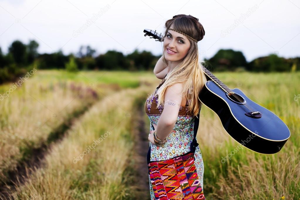 Beautiful hippie girl with a guitar