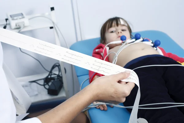 Young woman doctor cardiologist makes a survey — Stock Photo, Image