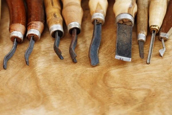 Carving tool closeup on wooden background — Stock Photo, Image