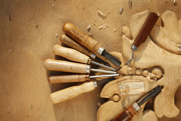 Carving tool closeup on wooden background — Stock Photo, Image