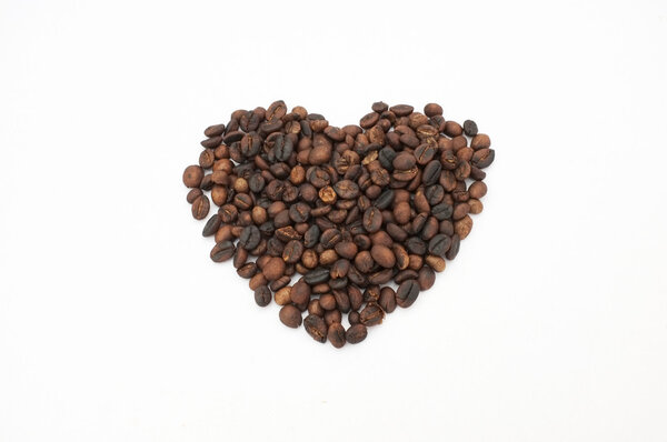 Coffee beans in heart shape isolated on white background