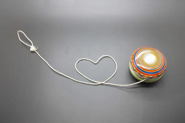 Vintage yoyo with twine rolling in heart shape — Stock Photo, Image