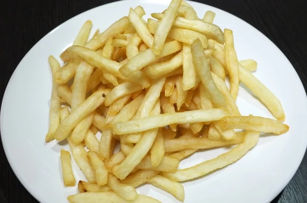Heap of fried potato chip sticks on white dish — Stock Photo, Image