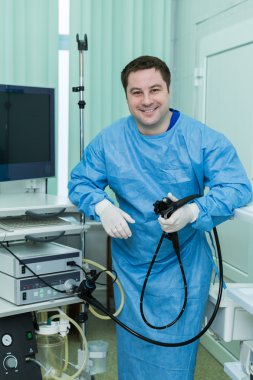 Smiling endoscope doctor in examine room