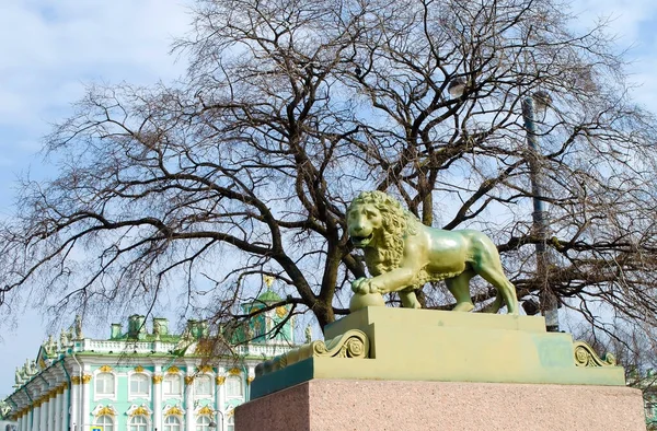 Lion statue on the background of the Winter Palace (Hermitage) in St. Petersburg, Russia