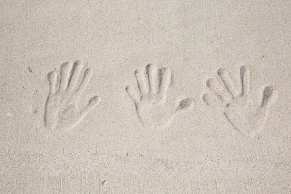 Children handprints on the sand — Stock Photo, Image