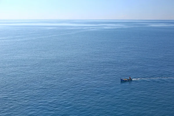 Small fishing boat in calm sea — Stock Photo, Image